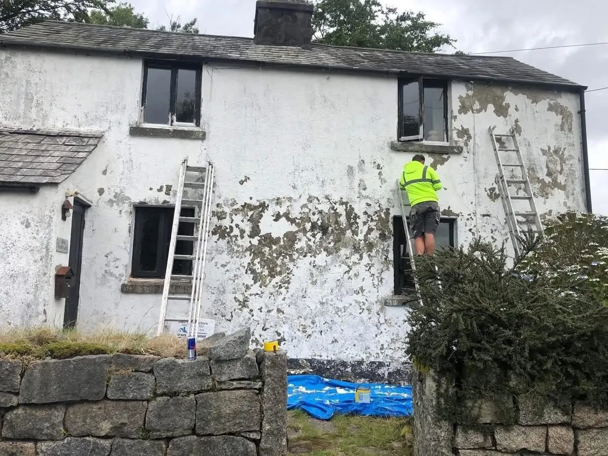 Cottage with blown, flaking render before repair in Exmouth